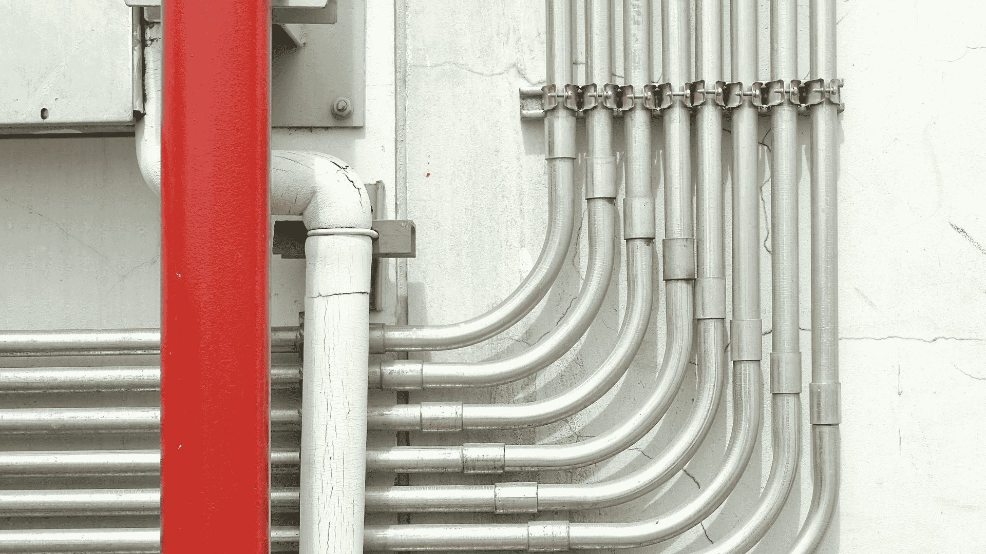 Close up of aluminum electrical conduit and wiring system inside building