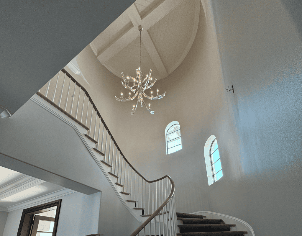 Electrician repairing interior light fixture and home wiring system